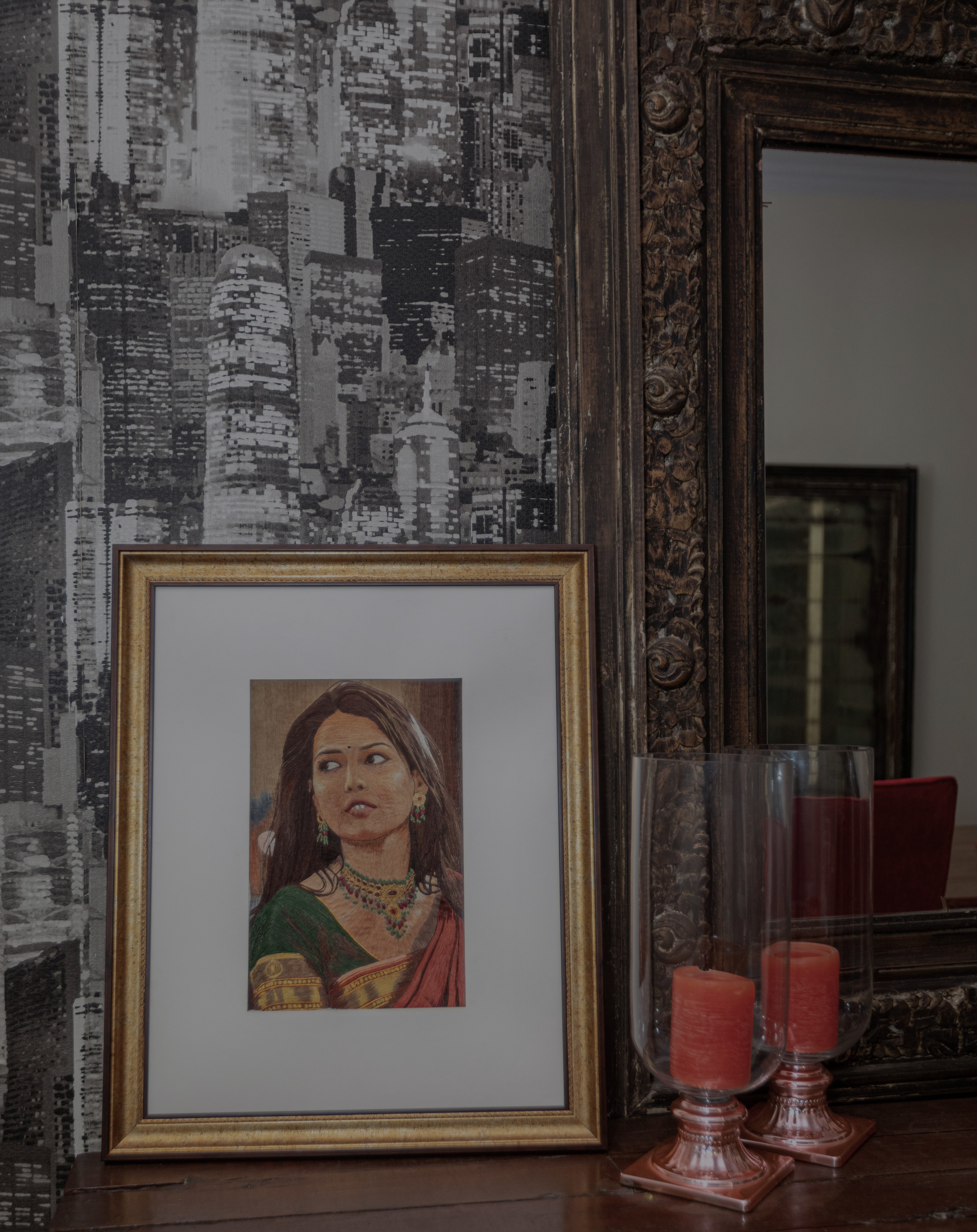 This piece shows a doe-eyed young woman in traditional Indian finery. Play of light and shadows on the contours of the face, along the hair and in the folds of the sari add requisite depth
The bright colour tones of saffron, gold and green have been balanced by the subtle browns.